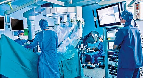 Doctors operate a robotic surgical system at Kidwai Memorial Institute of Oncology