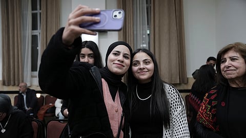 Dania Hanatsheh, right, a former Palestinian prisoner who was released from an Israeli prison as part of a ceasefire deal between Israel and Hamas, poses for a photo at a reception for released prisoners, West Bank city of Ramallah, Monday, Jan. 20, 2025.