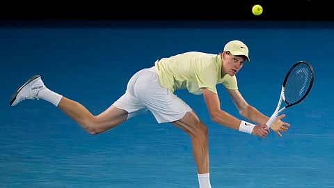 Jannik Sinner of Italy plays a backhand return to Alex de Minaur of Australia during their quarterfinal match at the Australian Open tennis championship in Melbourne, Australia, Wednesday, Jan. 22, 2025.