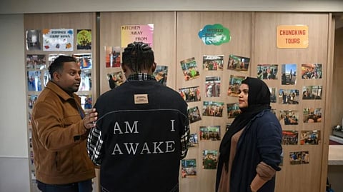Uzma Naveed (R), an outreach coordinator, and social worker Jeffrey Andrews (L) speaking to ‘John’ (C) at the Christian Action Centre for Refugees in Chungking Mansions in Hong Kong, Jan. 25, 2025.