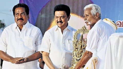 A resident of Vallalapatti gifting an idol to Chief Minister M K Stalin thanking him for his efforts, in Madurai on Sunday 
