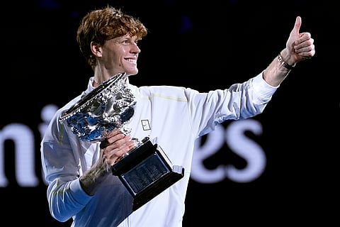 Jannik Sinner of Italy gestures as he carries the Norman Brookes Challenge Cup after defeating Alexander Zverev of Germany in the men's singles final at the Australian Open tennis championship in Melbourne, Australia, Sunday, Jan. 26, 2025.