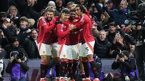 Manchester United's Lisandro Martinez, center, is congratulated after scoring his side's opening goal during the EPL soccer match between Fulham and Manchester United on Sunday, Jan. 26, 2025. 