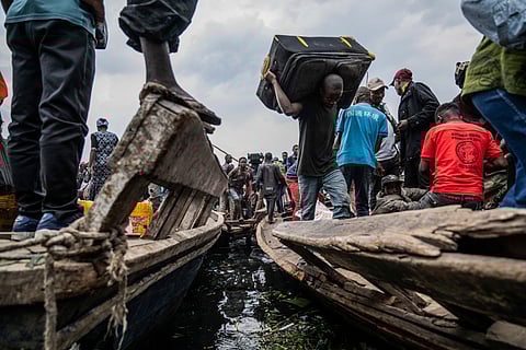 People fleeing M-23 rebel advances arrive by boat in Goma, Democratic Republic of the Congo, Wednesday, Jan. 22, 2025.