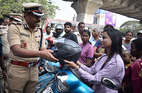 Coimbatore Police Commissioner A Saravana Sundar handing out helmets as part of Road safety month in January. 