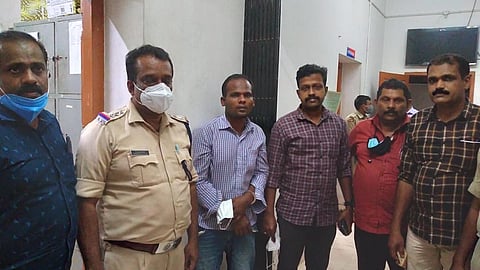 The investigation team with the serial killer Rajendran (third from right)