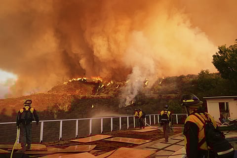 Fire crews monitor the Palisades fire in Mandeville Canyon, Jan 11, 2025 in Los Angeles.