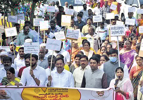 MP Kesineni Sivanath, NTR Collector G Lakshmisha and other officials take part in a rally to raise awareness on PM Surya Ghar scheme in Vijayawada 
