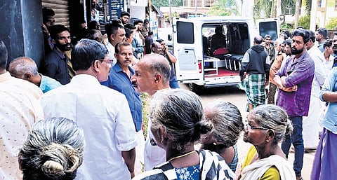 Residents  gather near the house at Balaramapuram where the toddler was thrown into the well by her uncle