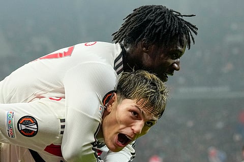 Manchester United's Kobbie Mainoo celebrates with Alejandro Garnacho after scoring his side's second goal during the Europa League league phase soccer match between FCSB and Manchester United at the National Arena stadium, Thursday, Jan. 30, 2025.