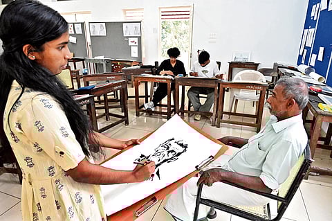A student makes a drawing of a live model 