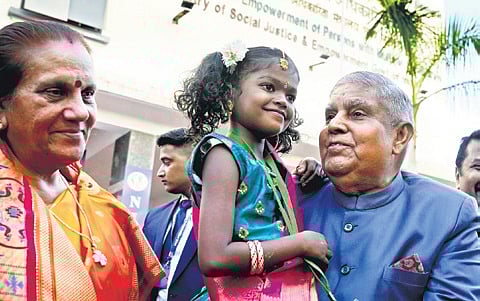 Dhankhar with a child with disability during the event 