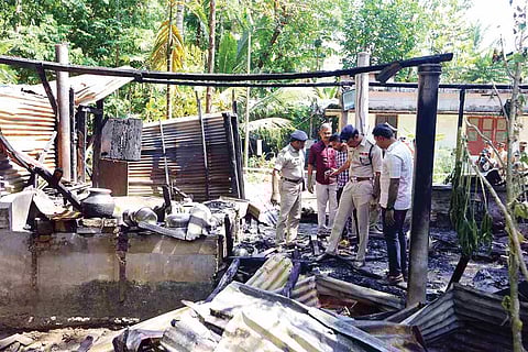 Police inspect the gutted house at Kottamuri, near Chennithala