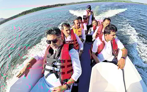 Deputy Chief Minister DK Shivakumar takes a speed boat ride while inspecting the Kanva dam, during a public event in Channapatna on Sunday.