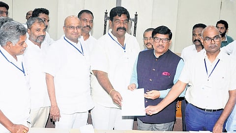 Guntur Municipal Commissioner P Srinivasulu presenting certificates to the winners of Standing Committee elections on Monday 