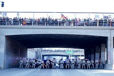 Law enforcement personnel stage in front of a group of demonstrators who shut down the 101 freeway during a protest calling for immigration reform Sunday, Feb. 2, 2025, in Los Angeles.
