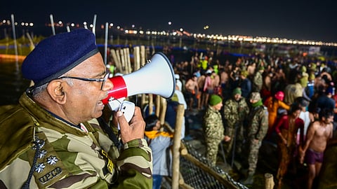 A security personnel makes announcements as devotees gather to take a holy dip at the Sangam on the occasion of Basant Panchami during the ongoing Maha Kumbh Mela, in Prayagraj.