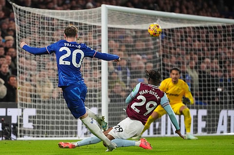 West Ham's Aaron Wan-Bissaka scores an own goal besides Chelsea's Cole Palmer during the English Premier League soccer match between Chelsea and West Ham United.