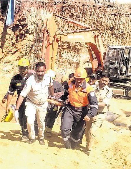 Officials shift the body of a worker killed at the construction site in LB Nagar, Hyderabad, on Wednesday