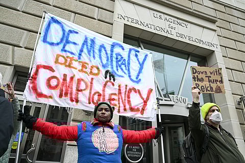 People protest outside of the headquarters for United States Agency for International Development (USAID), before Congressional Democrats hold news conference in Washington, DC, on February 3, 2025. 