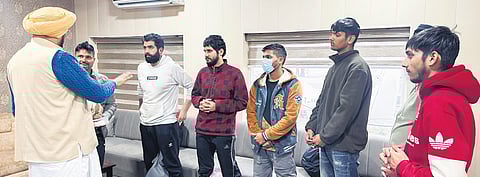 Punjab minister Kuldeep Singh Dhaliwal interacts with deportees.