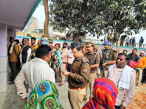This photo shared by SP chief Akhilesh Yadav reportedly shows Ayodhya police checking the ID cards of voters in Milkipur. 