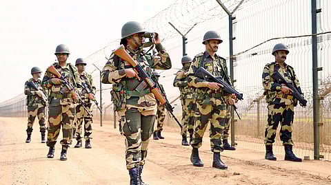 Border Security Force (BSF) personnel keep vigil along the India-Bangladesh border on Republic Day, near Atila BOP in South Dinajpur on Jan. 26, 2025. 