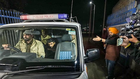 Police personnel take deported immigrants for initial questioning after a US military aircraft carrying them landed at the Shri Guru Ramdas Ji International Airport, in Amritsar.