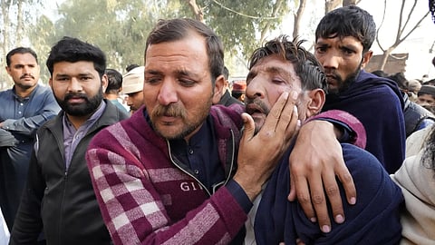 Ramzan Khan, second right, father of Muhammad Arslan, a victim of last month's migrant boat capsizing off West Africa's Atlantic coastline, is comforted by his elder son before a funeral prayer in Mirza Virkan village, in the Sheikhpura district, Pakistan, Thursday, Feb 6, 2025.