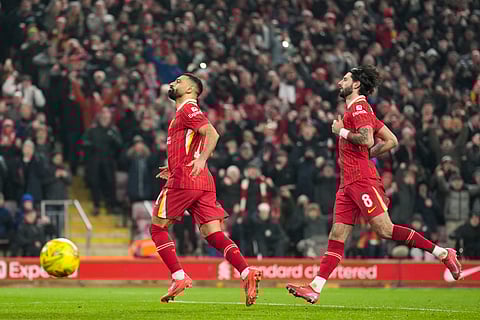 Liverpool's Mohamed Salah, left, celebrates with Dominik Szoboszlai after scoring the second goal from the penalty spot during the English League Cup semifinal second leg soccer match between Liverpool and Tottenham Hotspur