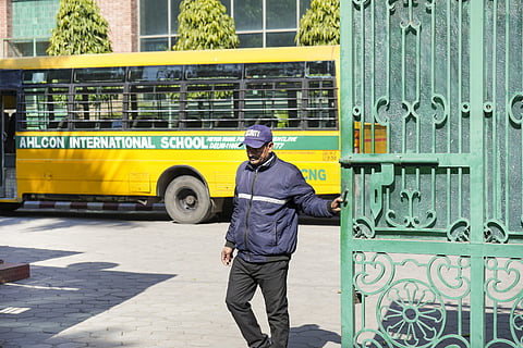 FIle Photo | A security personnel closes the gate at the Ahlcon International School after it received a bomb threat, in New Delhi