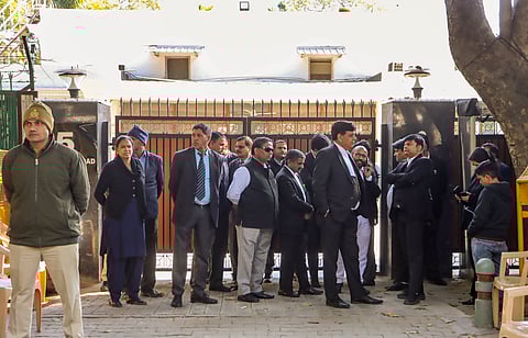 Security personnel, lawyers and other officials are seen outside the residence of former Delhi chief minister and Aam Aadmi Party (AAP) National Convener Arvind Kejriwal after an Anti-Corruption Branch (ACB) team reached his residence at 5, Ferozeshah Road, in New Delhi, Friday, Feb. 7, 2025