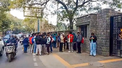 Students outside St. Stephen's College after it received a bomb threat, in New Delhi on Friday.