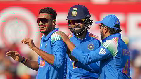 Axar Patel (left) celebrates Jos Buttler's wicket with India captain Rohit Sharma (right) and wicketkeeper KL Rahul on Thursday