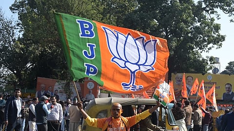 BJP workers celebrate outside the Delhi BJP office in New Delhi on Saturday.