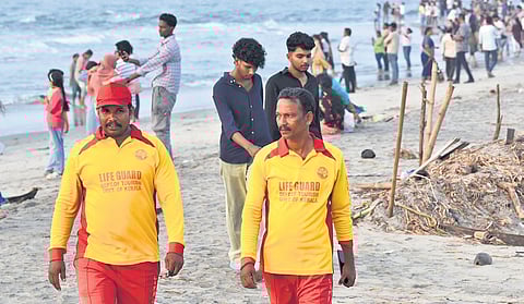 Lifeguards Sudhir P C and Ranjith C P on duty at Fort Kochi beach.