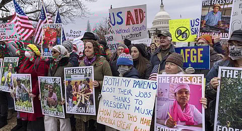 Demonstrators and lawmakers rally against President Donald Trump and his ally Elon Musk as they disrupt the federal government, including dismantling the U.S. Agency for International Development, which administers foreign aid approved by Congress, on Capitol Hill in Washington, Wednesday, Feb. 5, 2025.
