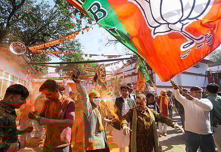 BJP supporters celebrate the party's decisive lead in the Delhi Assembly polls as counting of votes is underway, outside the Delhi BJP office.