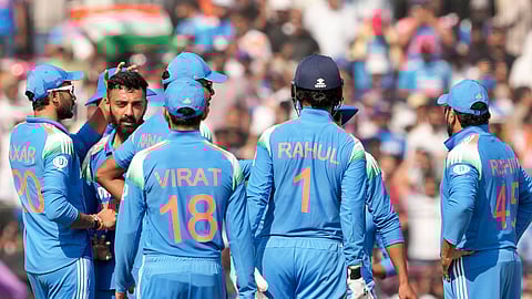 Varun Chakravarthy celebrates his maiden ODI wicket with teammates on Sunday
