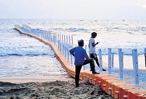 Workers assembling the floating bridge and readying it for safety inspections at Papanasam Beach in Varkala. The operations of the bridge were stalled after an accident that injured around 15 people nearly a year ago 