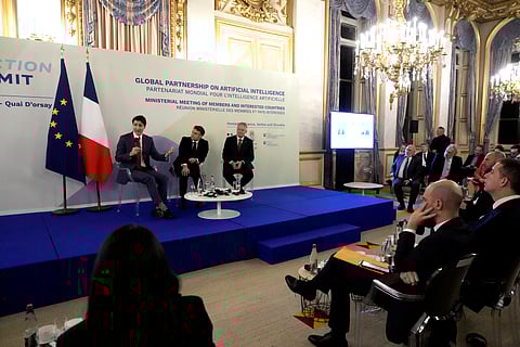 French President Emmanuel Macron (Center), Canada's Prime Minister Justin Trudeau (Left), and Secretary General of the OECD Mathias Cormann at the French Foreign Ministry ahead of the AI Action Summit in Paris, Sunday, Feb. 9, 2025.