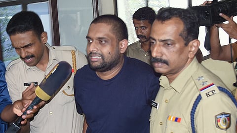 Police accompany Ananthu Krishnan, the accused in the half-price scam, to Ashoka Flats near the High Court in Kochi for evidence collection on Sunday.