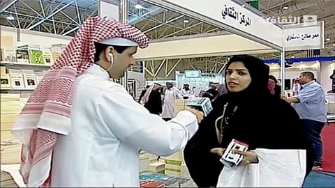 In this frame grab from Saudi state television footage, doctoral student and women's rights advocate Salma al-Shehab speaks to a journalist at the Riyadh International Book Fair in Riyadh, Saudi Arabia.