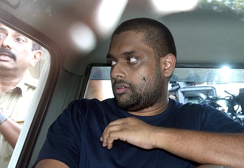 Police accompany Anandhu Krishnan, the accused in the half-price scam, to Ashoka Flats near the High Court in Kochi for evidence collection on February 9 (Photo | Express)