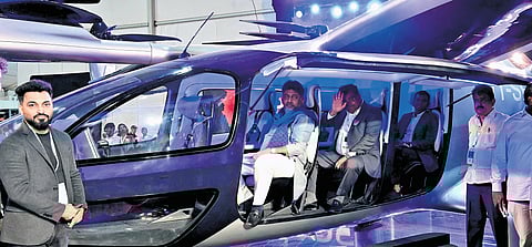 Deputy CM DK Shivakumar and Industries Minister MB Patil check out an air taxi during the Invest Karnataka Global Investors Meet at Palace Grounds in Bengaluru on Wednesday.