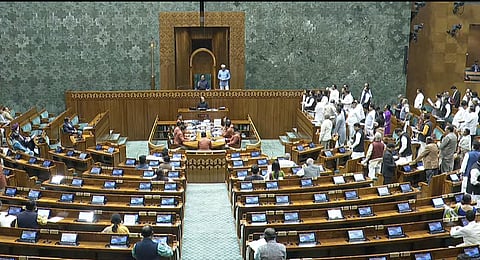 Opposition members raise slogans in the Lok Sabha during the ongoing Budget Session, in New Delhi on Thursday, Feb. 13, 2025.