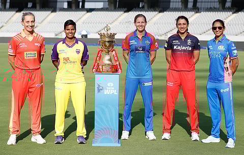(from left) WPL captains Ashleigh Gardner (Gujarat Giants), Deepti Sharma (UP Warriorz), Meg Lanning (Delhi Capitals), Smriti Mandhana (Royal Challengers) and Harmanpreet Kaur (Mumbai Indians) with the WPL trophy