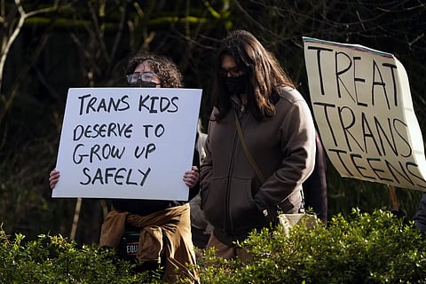 A pro-transgender rights protest outside Seattle Children's Hospital after the institution postponed some gender-affirming surgeries for minors following an executive order by President Donald Trump, Sunday, Feb 9, 2025. 