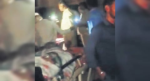 Doctors use smartphone torchlights to treat a patient in Ballari on Thursday