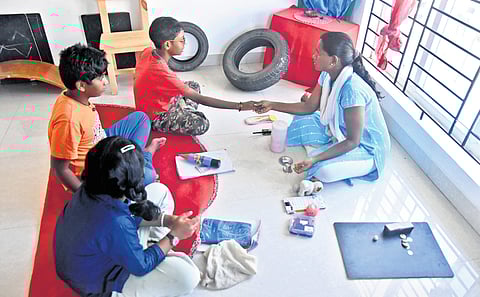 A Kreeyaa teacher guides students through a hands-on lesson, with practical examples 